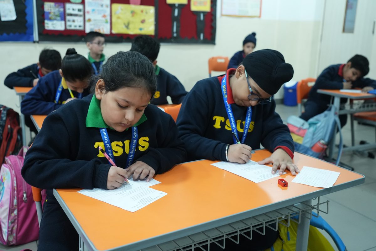 Primary students at TSUS Sarabha Nagar work on a mental maths sheet at their desks during a class